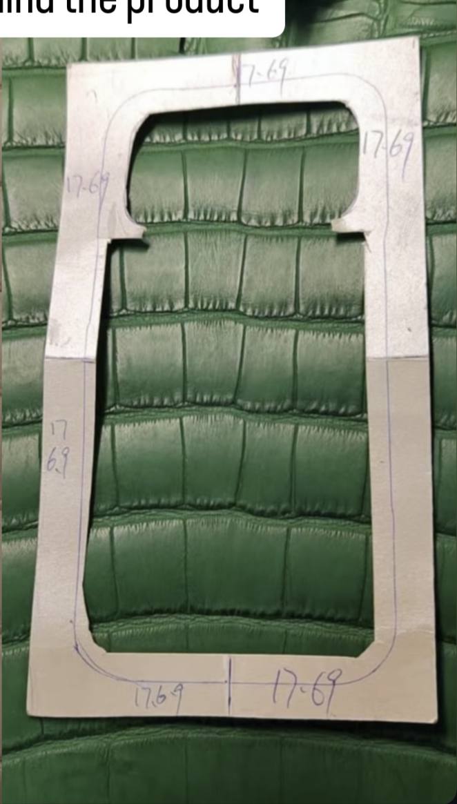 Cutting template over banknote-green crocodile hide